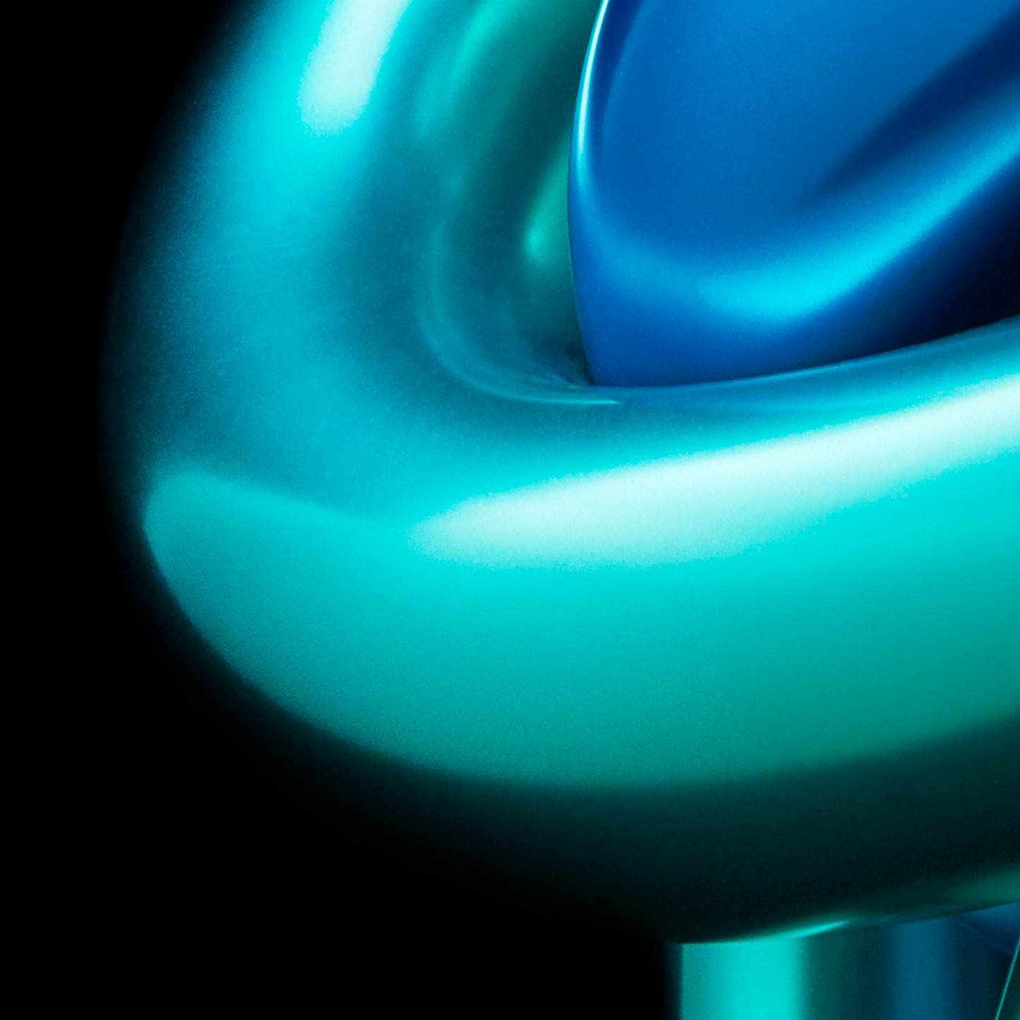 Close-up of a blue and green object with a glossy finish on a black background