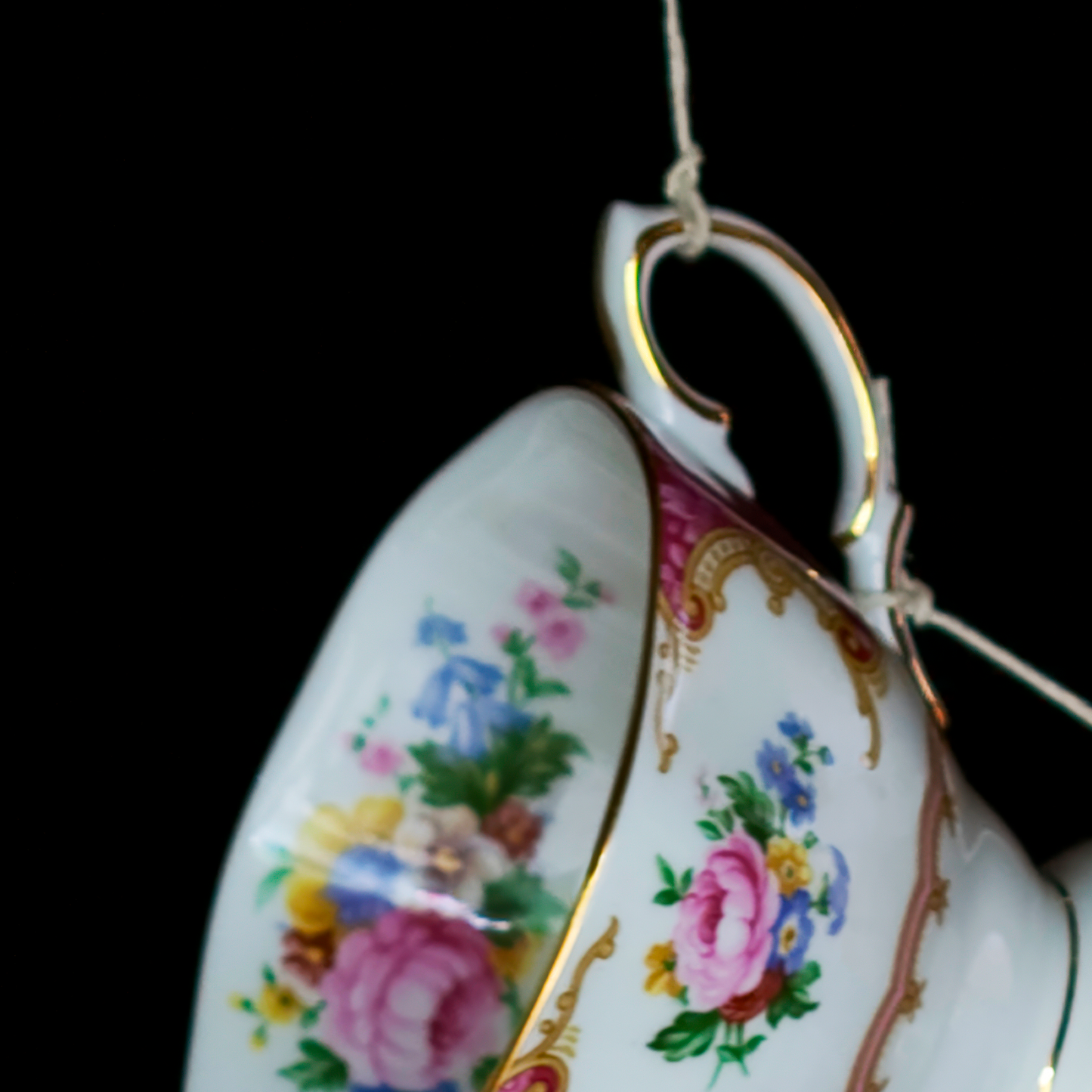 Decorative teacup with floral patterns on a black background