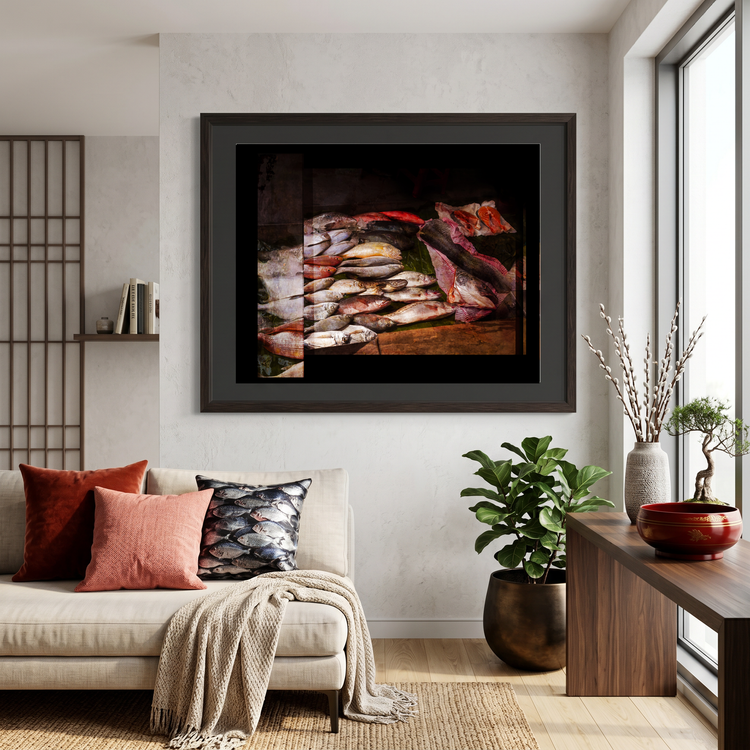Framed artwork above a sofa in a living room with plants and decor.