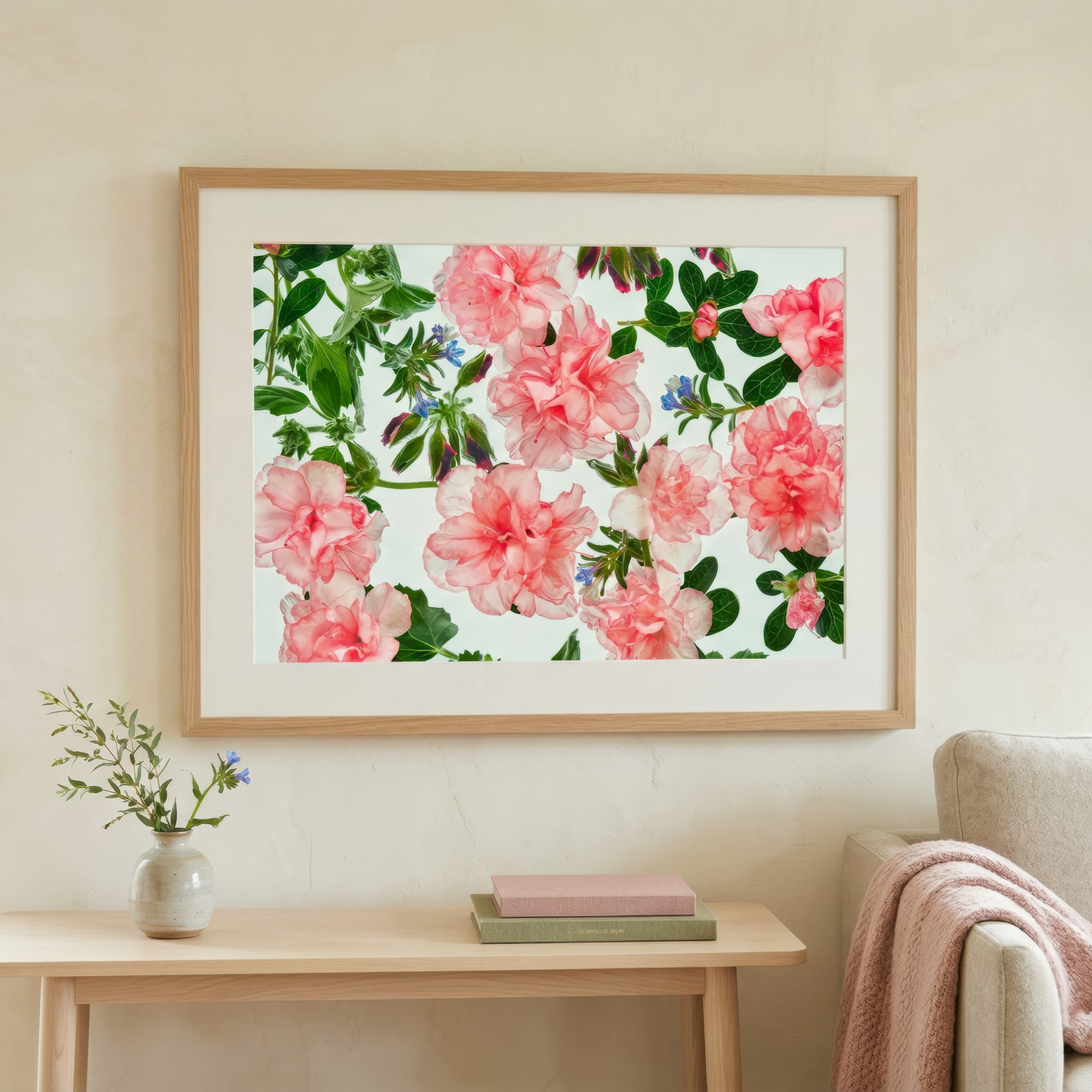 Floral artwork floating gardens 086a  in a wooden frame on a wall above a table with a vase and books.