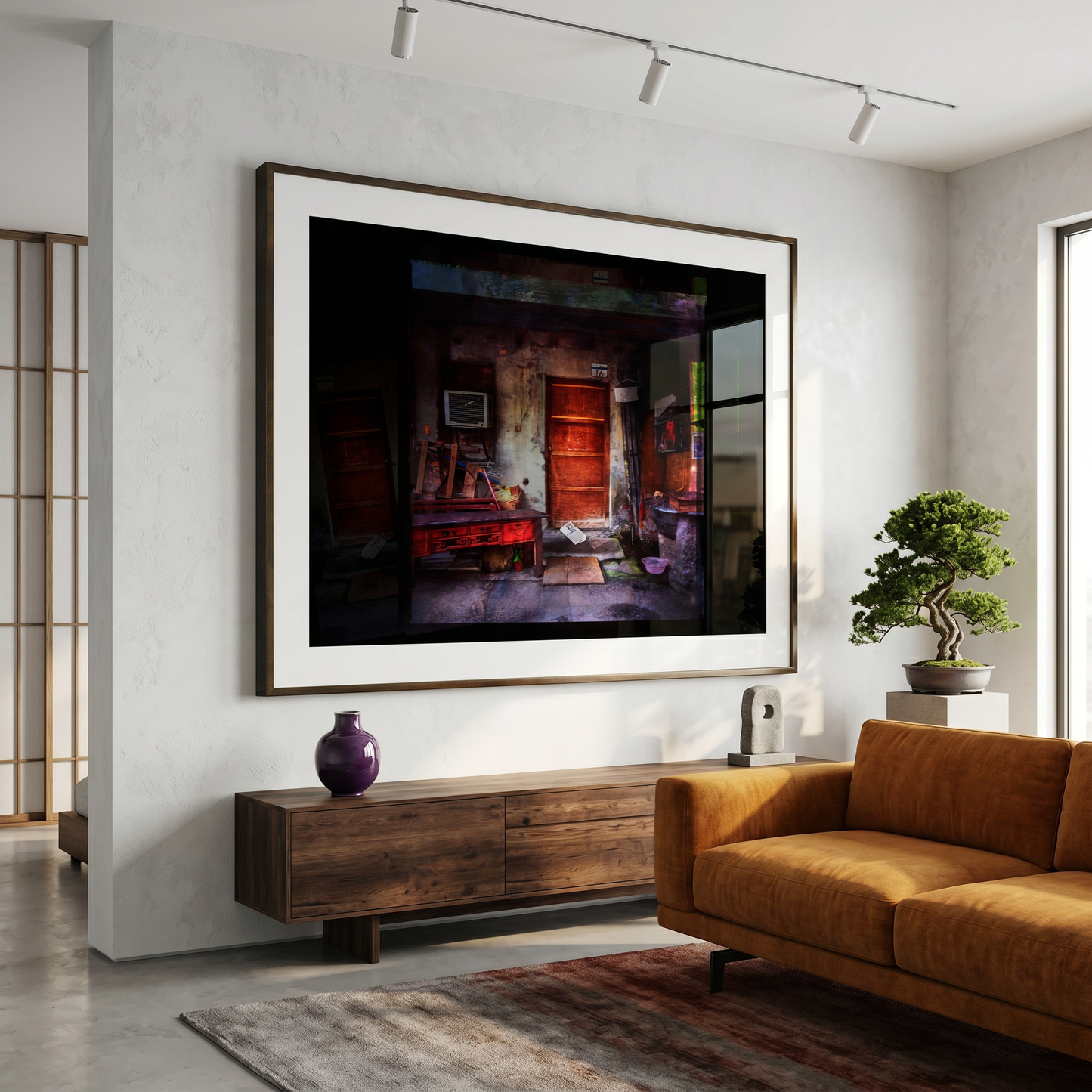 Living room with a large framed artwork on the wall, brown sofa, and wooden cabinet.