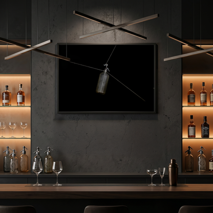 Modern bar setup with dark walls, shelves with bottles and glasses, and a mounted artwork
