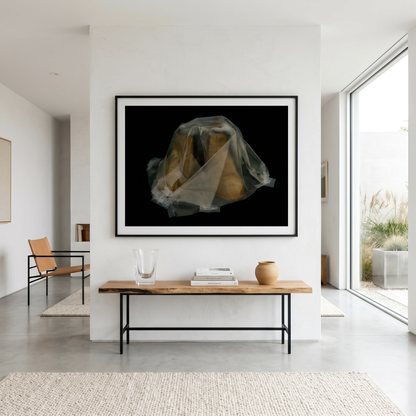 Modern interior with a framed artwork on the wall above a wooden table.
