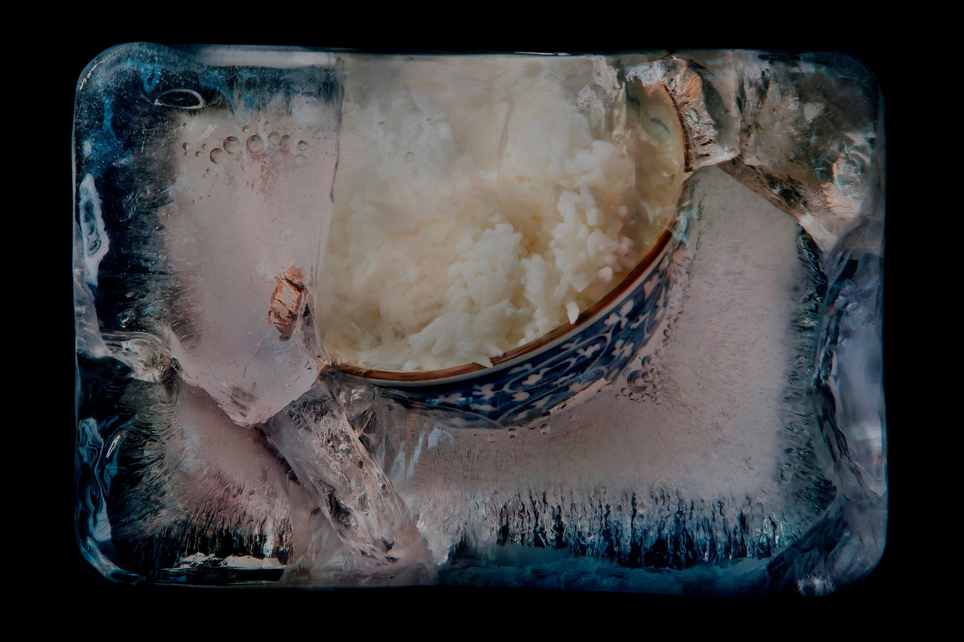 Bowl of rice frozen in ice a memory frozen in time on black