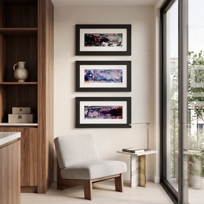 Three framed abstract art prints displayed together on a wall in a modern interior setting.
