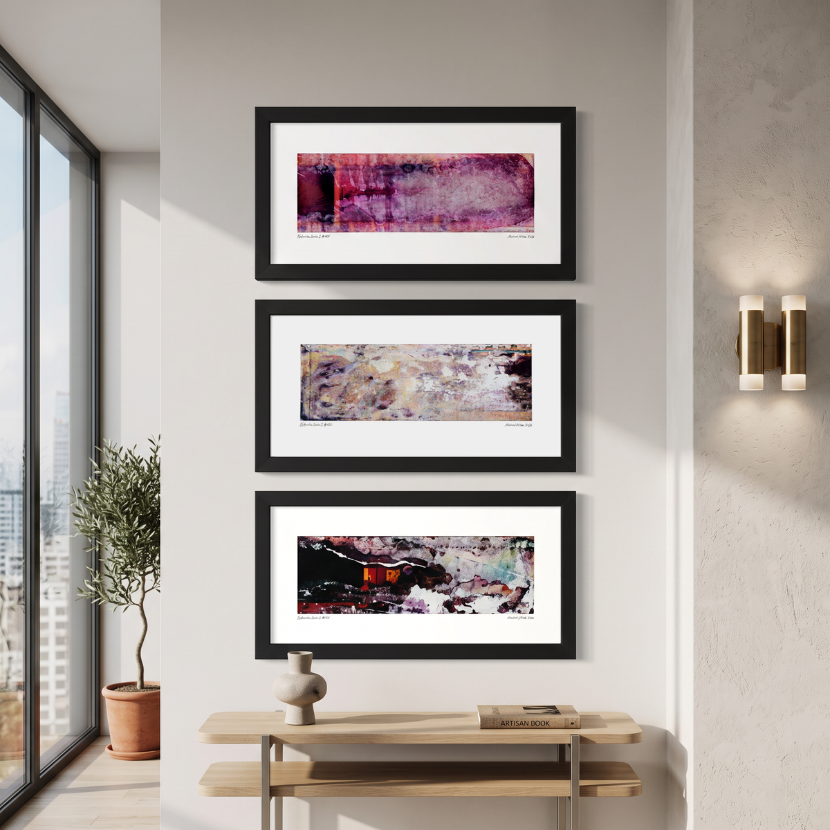 Three framed abstract art prints displayed together on a wall in a modern interior setting.
