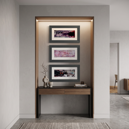 Three framed abstract art prints displayed together on a wall in a modern interior setting.
