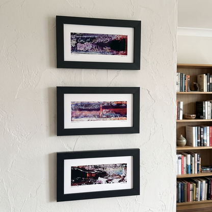 Three framed abstract art prints displayed together on a wall in a modern interior setting.
