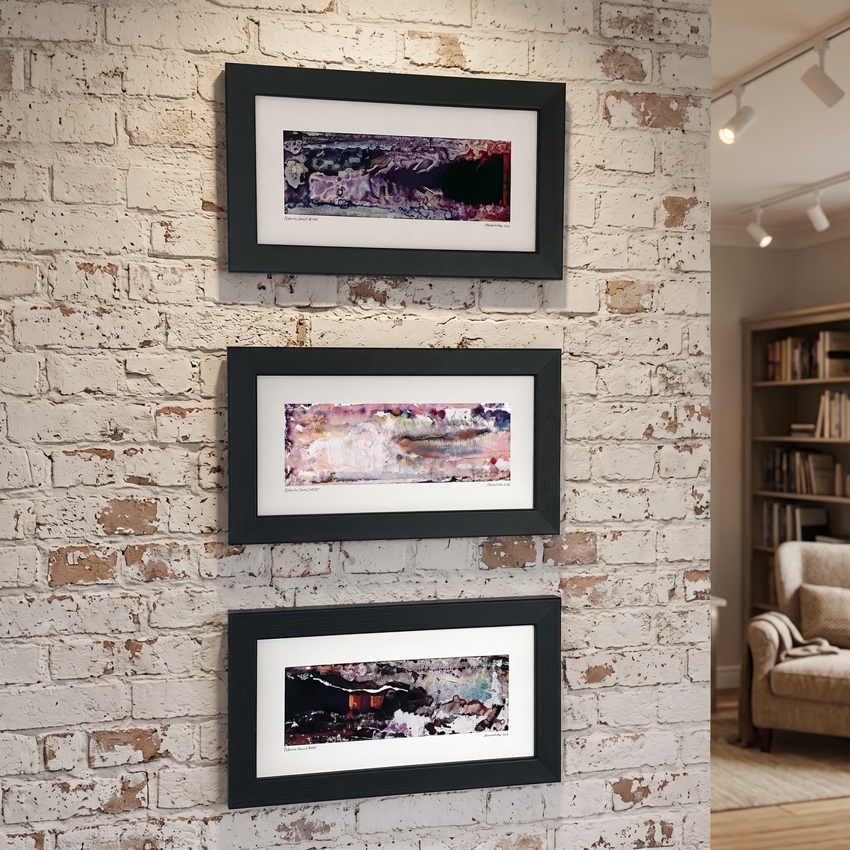 Three framed abstract art prints displayed together on a wall in a modern interior setting.
