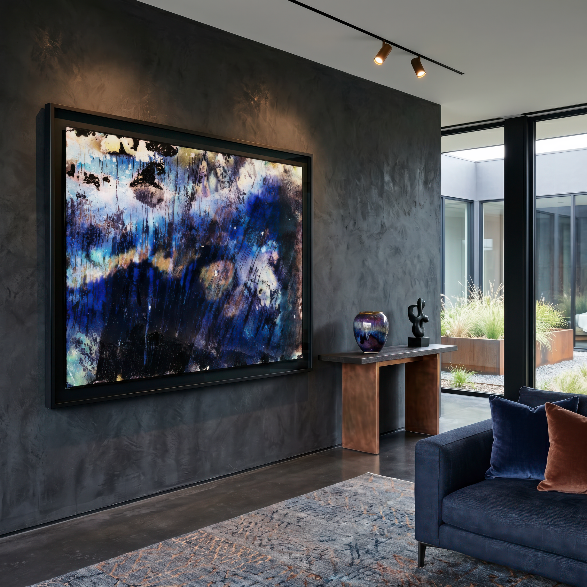 Modern living room with abstract painting on a dark wall, gray sofa, and decorative items.