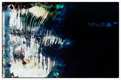 Abstract art with black, blue, and white brush strokes on a dark background
