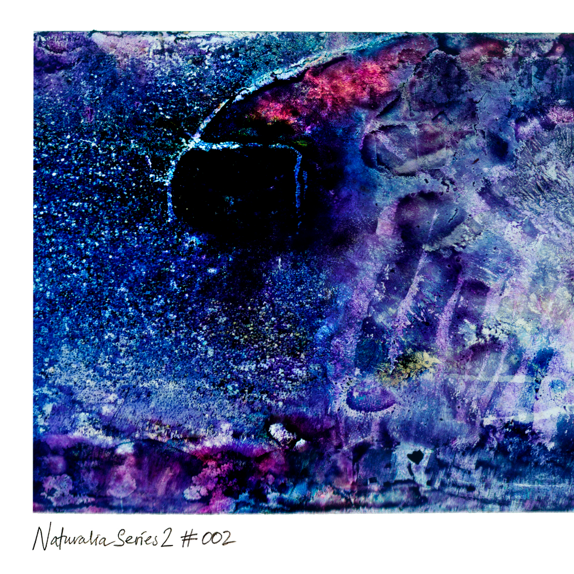 Abstract textured print with swirling blue, purple, and black tones, plus small pink and metallic-looking highlights, shown with the text 'Naturalia Series 2 #002' on a white margin below.