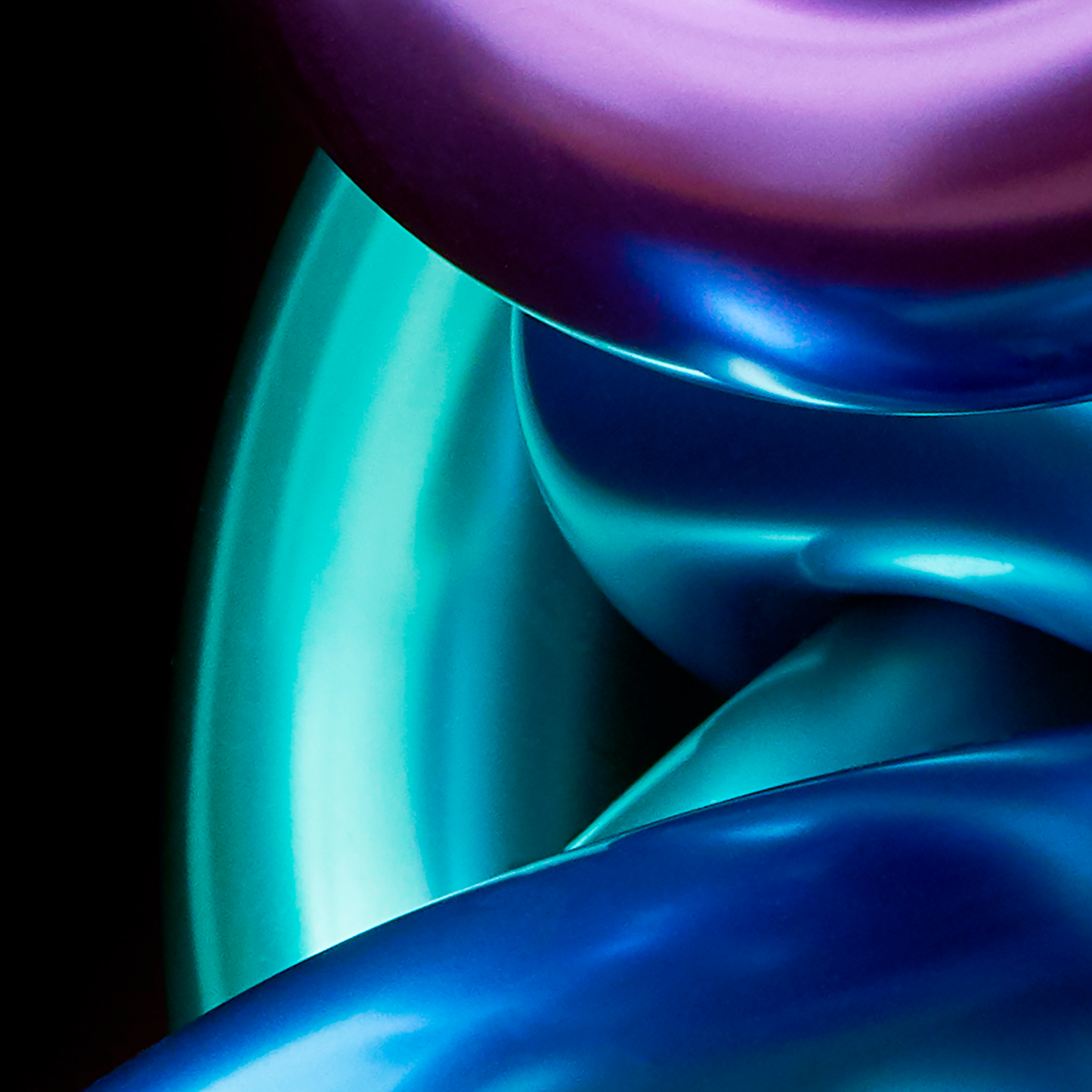 Close-up of iridescent blue and purple shapes on a black background