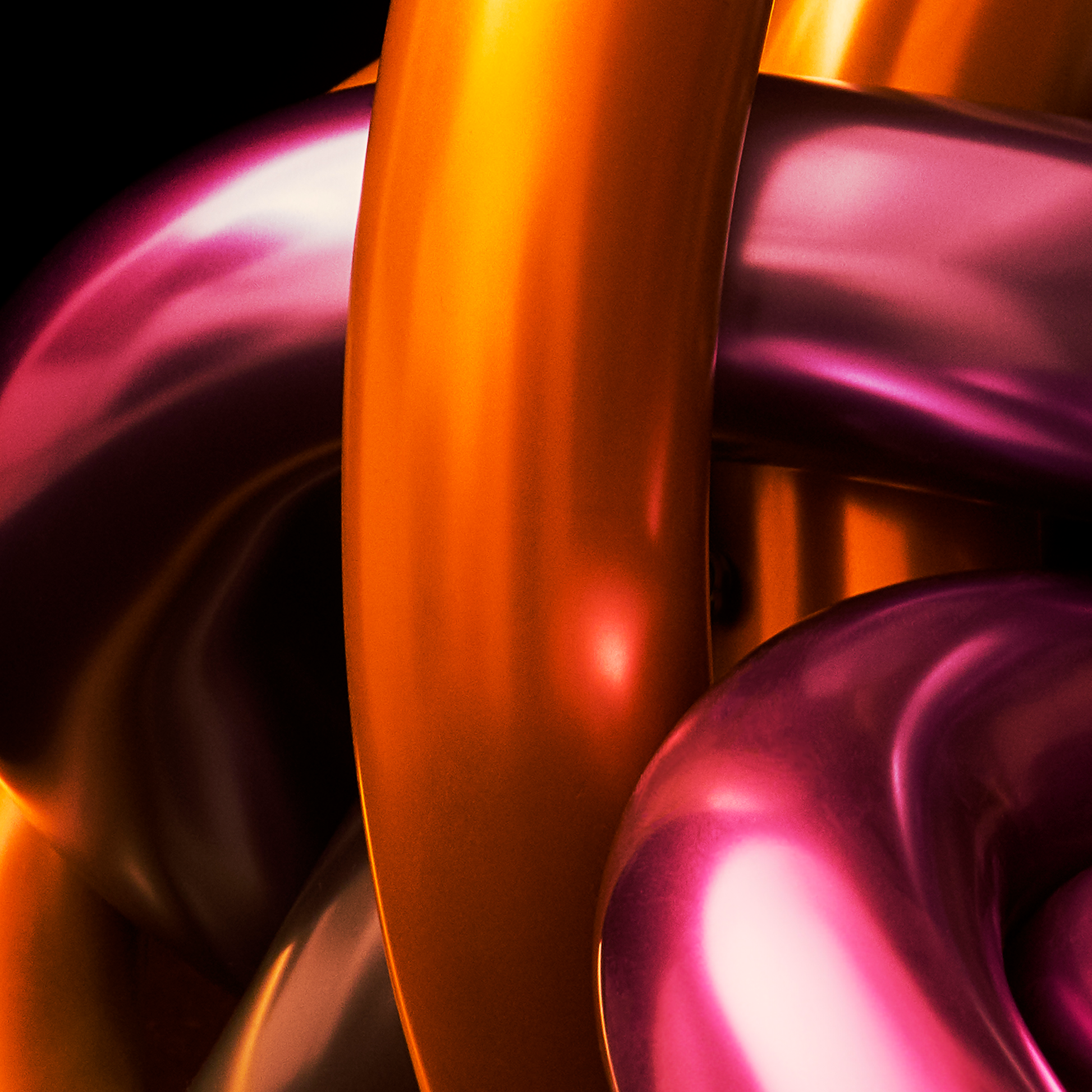 Close-up of a metallic object with orange and purple colors on a black background