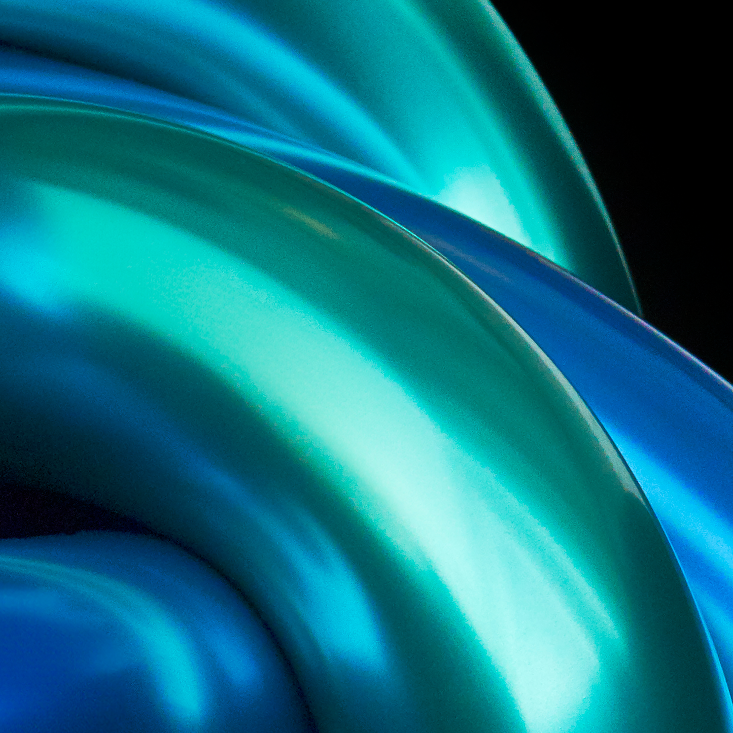 Close-up of blue and green metallic material with a glossy finish