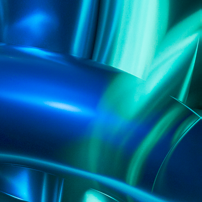 Close-up of a blue and green metallic surface with light reflections