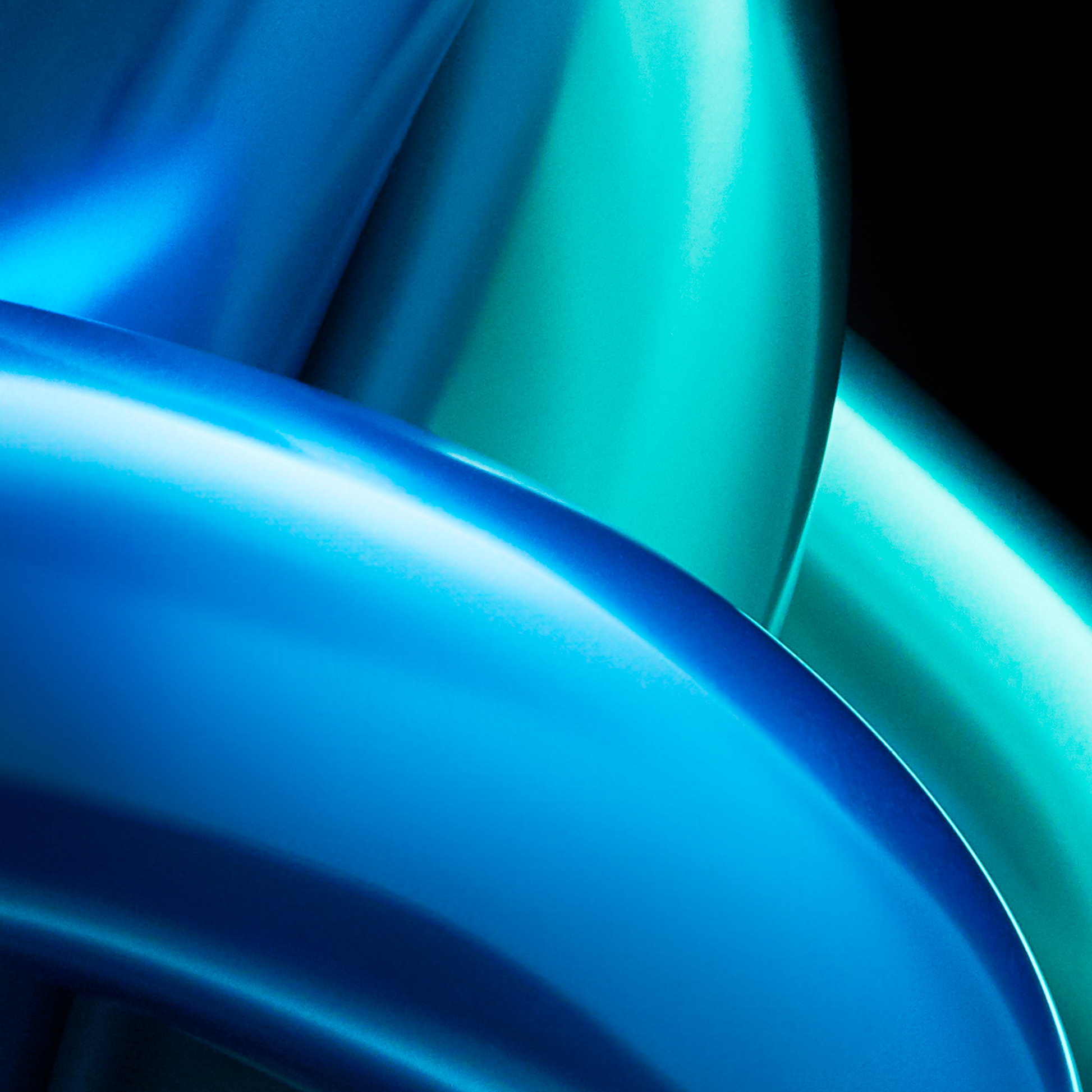 Close-up of blue and green metallic surfaces with a glossy finish.