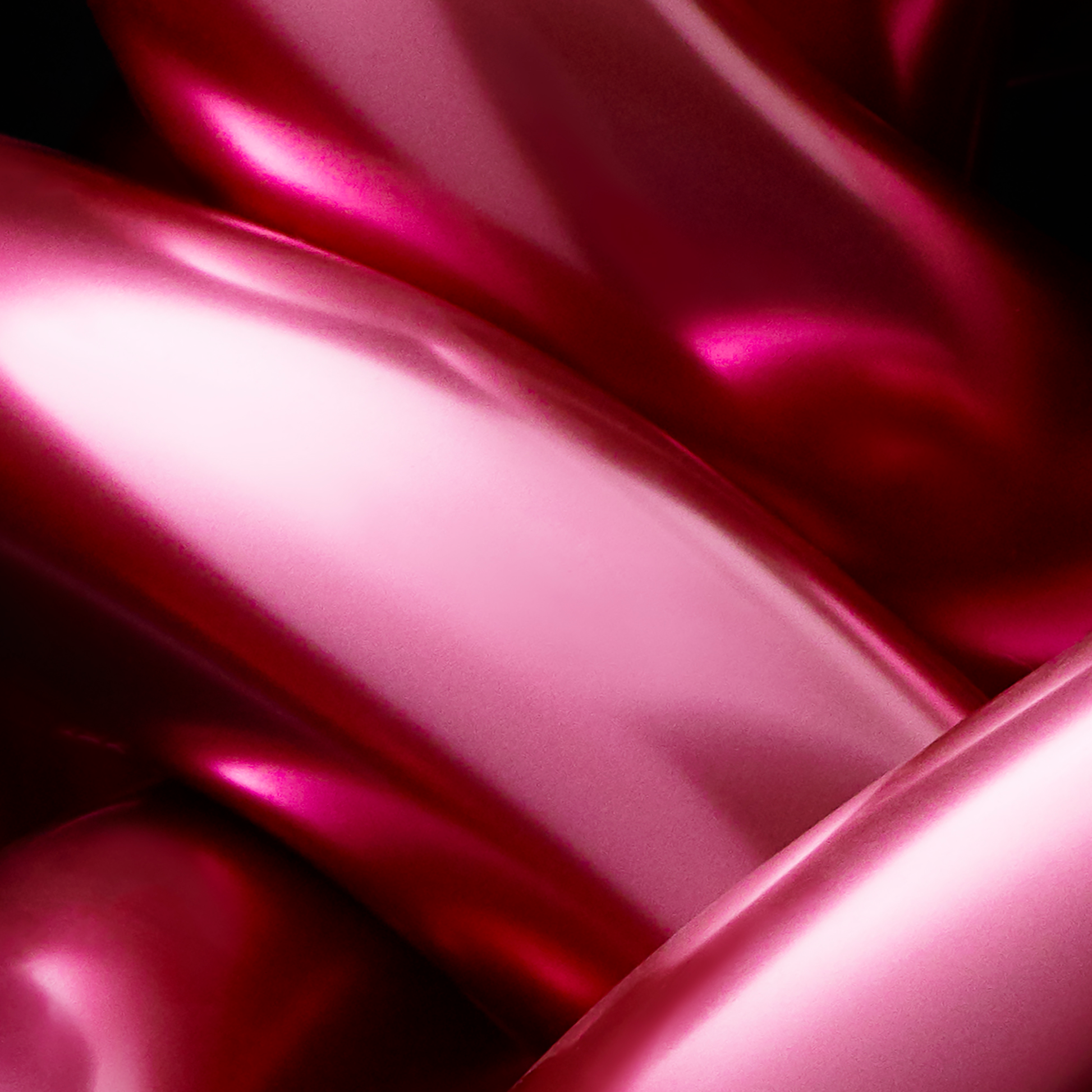 Close-up of pink satin object with a glossy finish