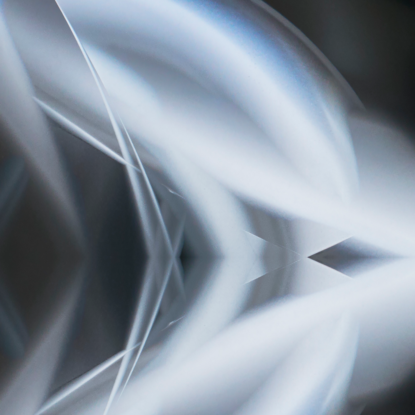 Abstract design with wavy lines and geometric shapes in gray and white.