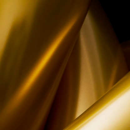 Close-up of a gold metallic surface with reflective properties