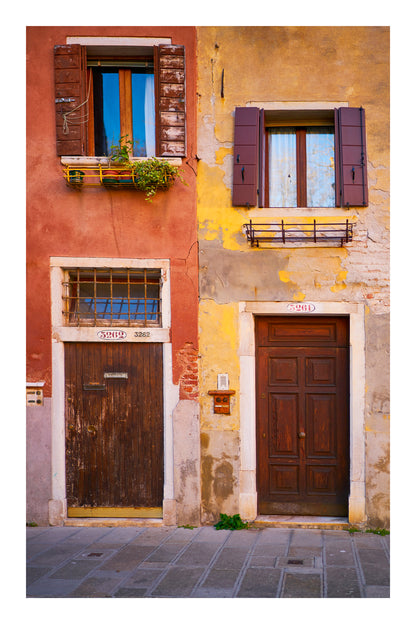 Two doors on a building with colorful walls in a city street setting in Venice Italy
