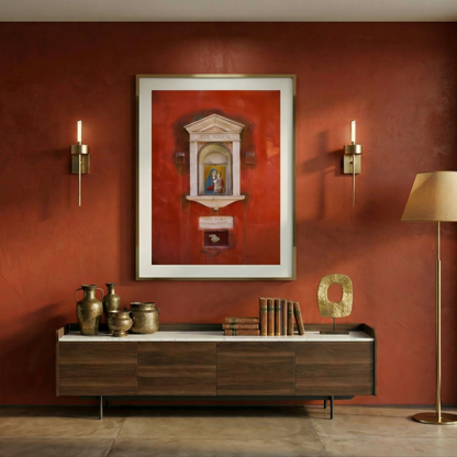 Modern interior with a red wall, a framed print of a religious decoration in Venice, a wooden console table, and decorative items.