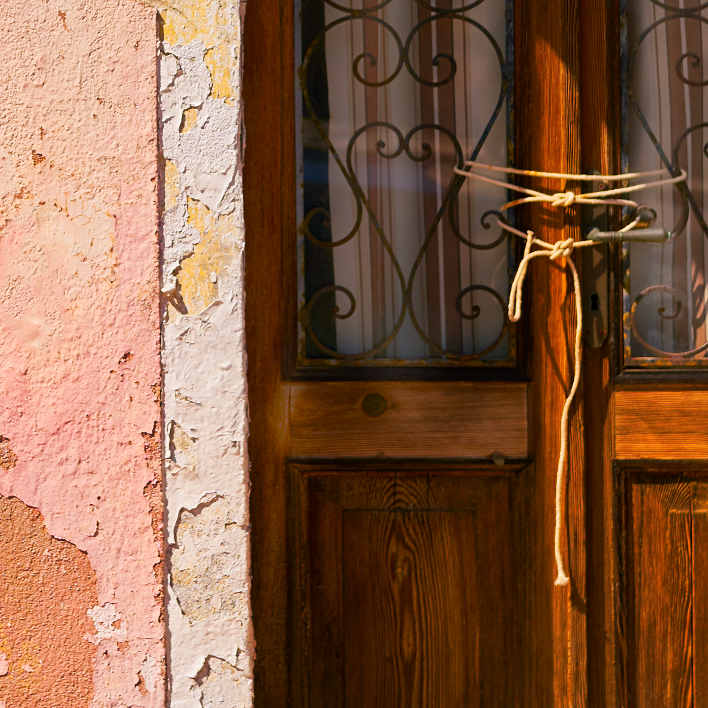 Close up of photograph showing door tied with string and crumbling paintwork