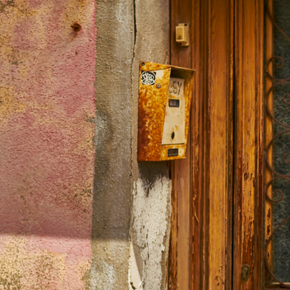 close up of photograph showing rusted intercomand faded paint