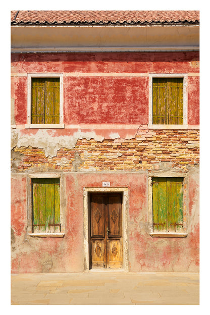 Old building with peeling paint and wooden door