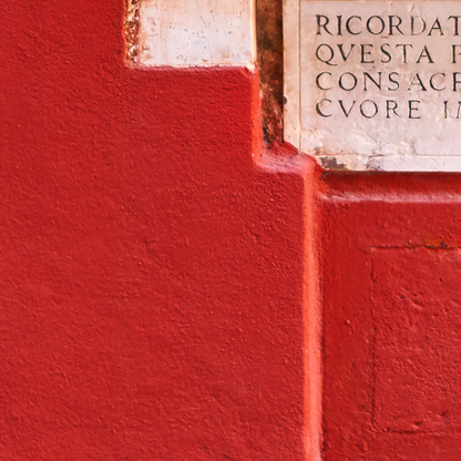 Red wall with a stone inscription