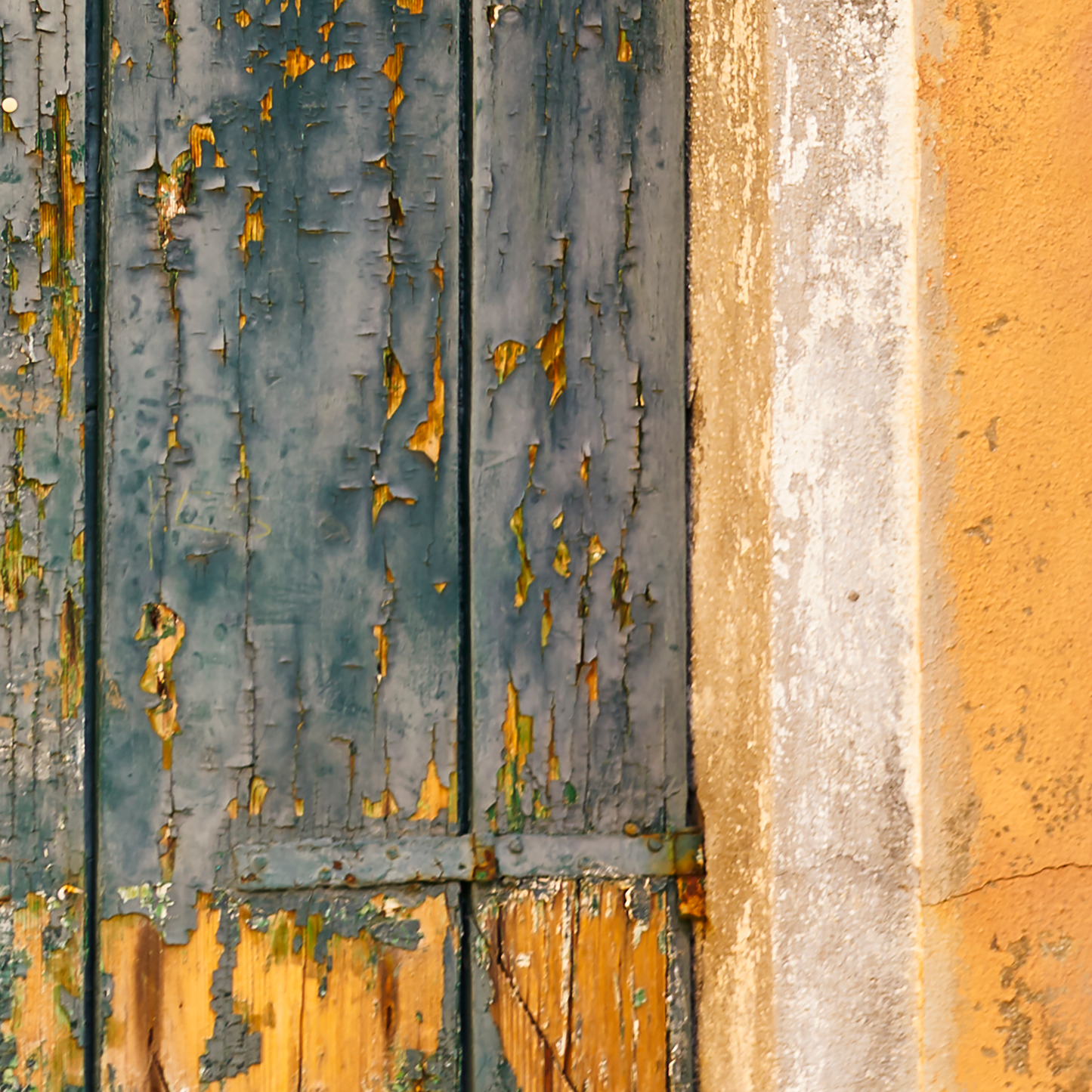 Close-up of a weathered wooden door with peeling paint