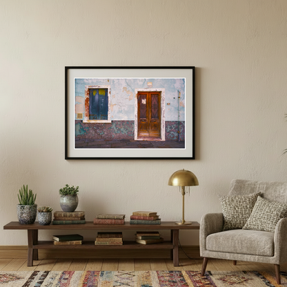 Living room with a framed artwork of Venice on the wall, a sofa, coffee table, and decorative items.