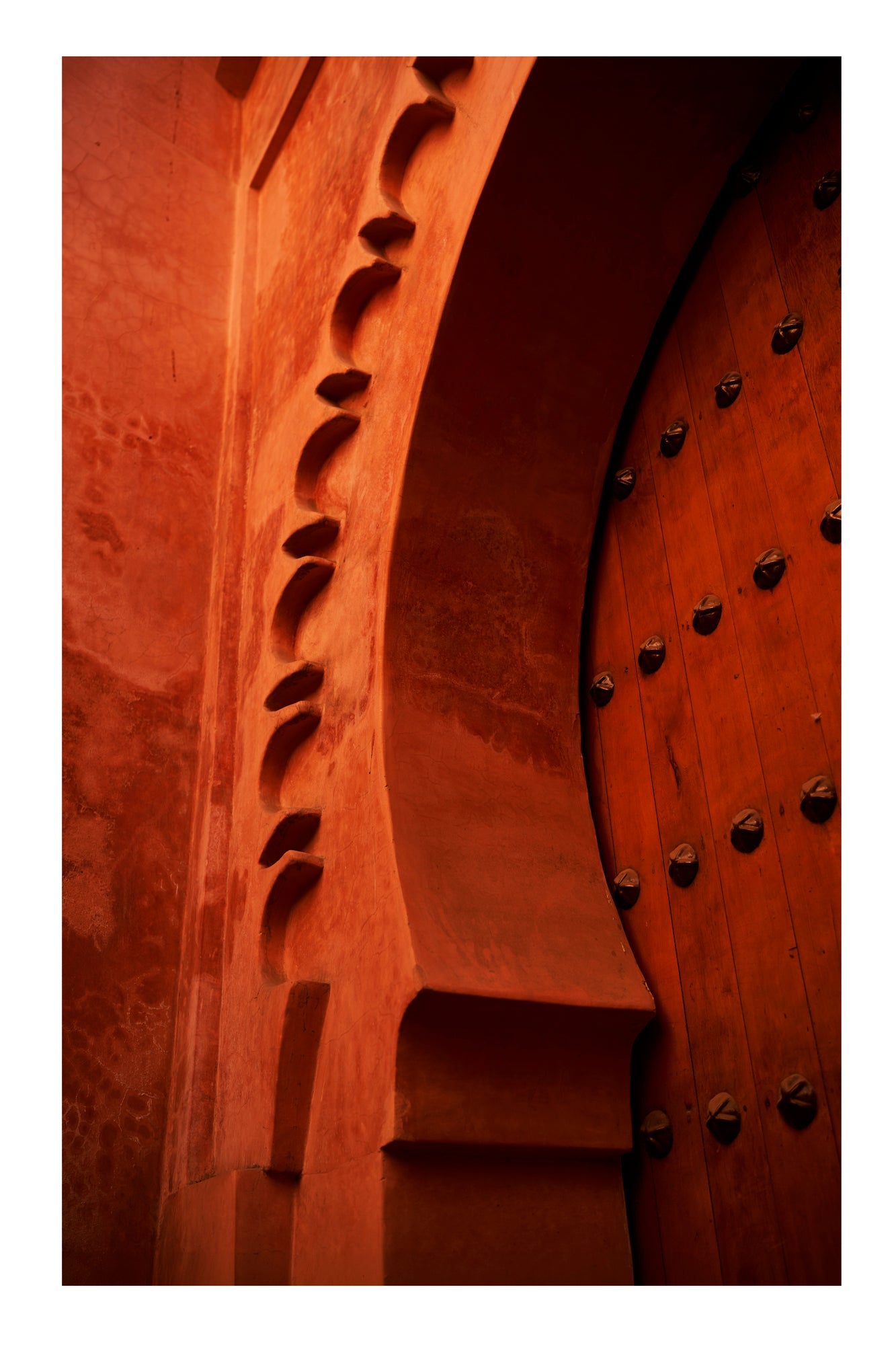 Close-up of a wooden door with intricate carvings and metal studs in Marrakesh Morocco