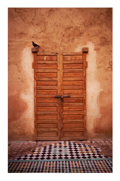 Wooden door on a textured wall with a checkered floor Marrakesh Morocco