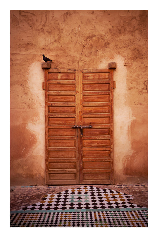 Wooden door on a textured wall with a checkered floor Marrakesh Morocco