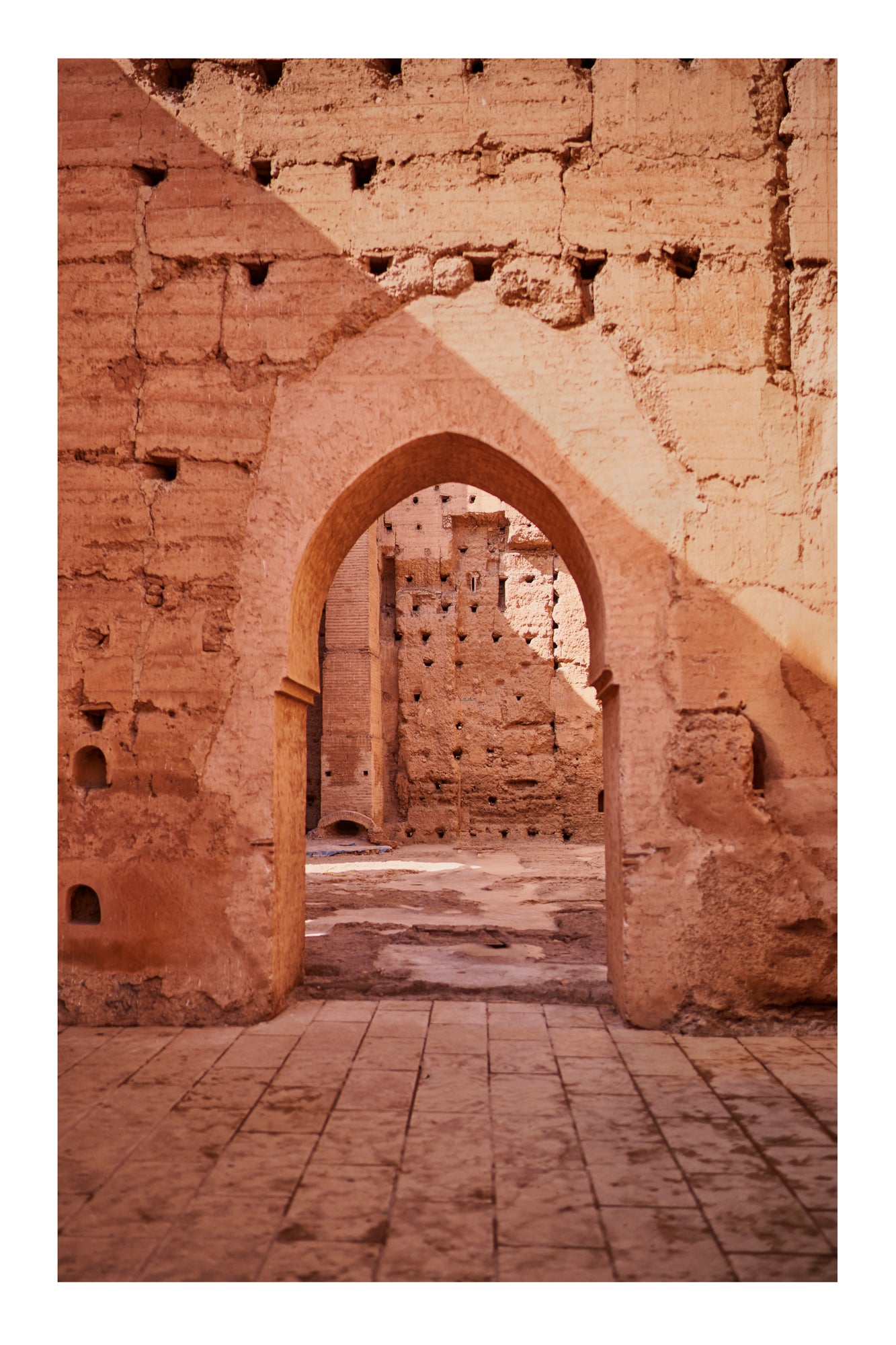 Archway in a stone wall with a patterned floor Marrakesh Morocco