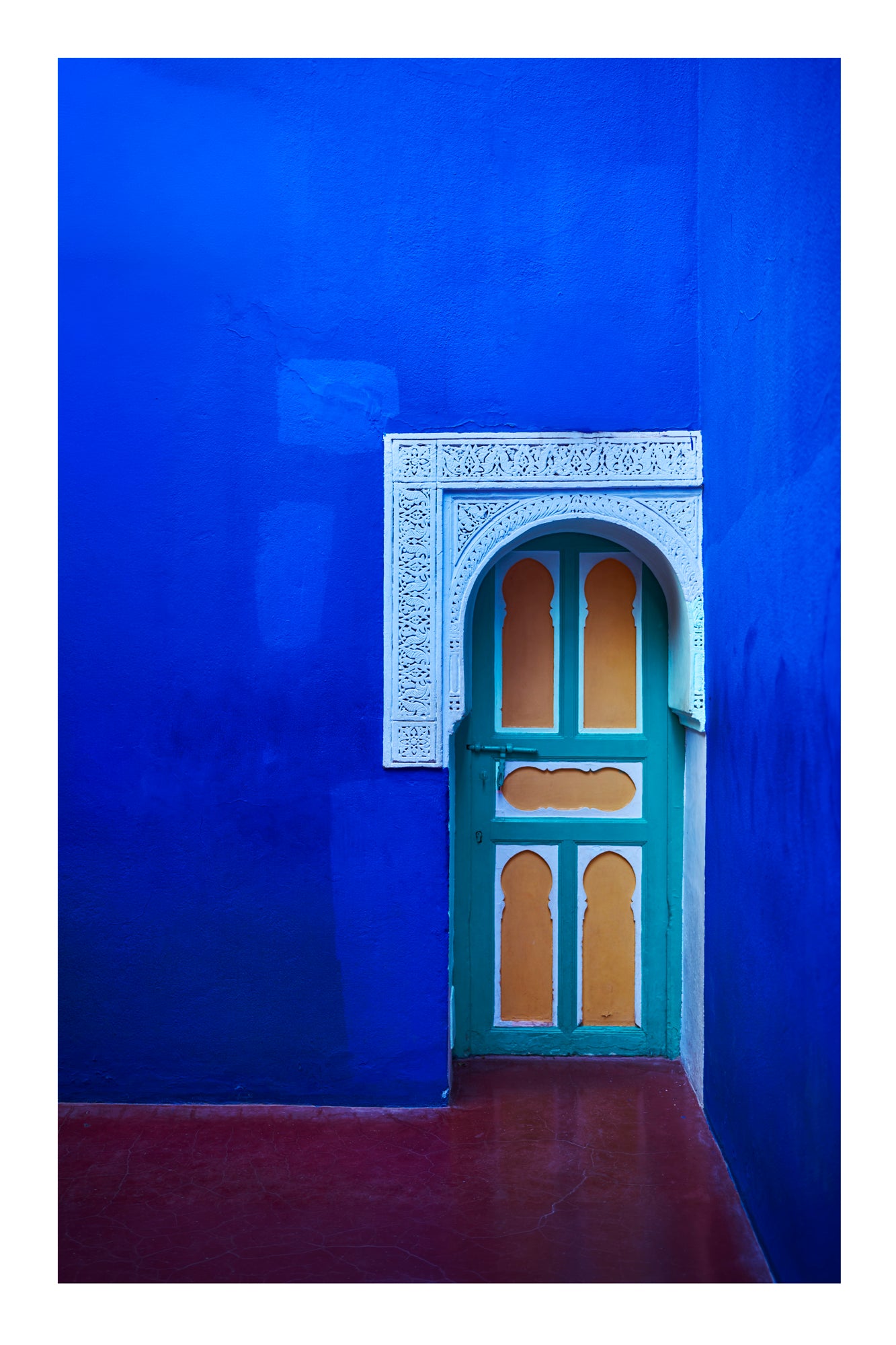 Decorative door with intricate patterns on a bright blue wall Jardin Majorelle Marrakesh