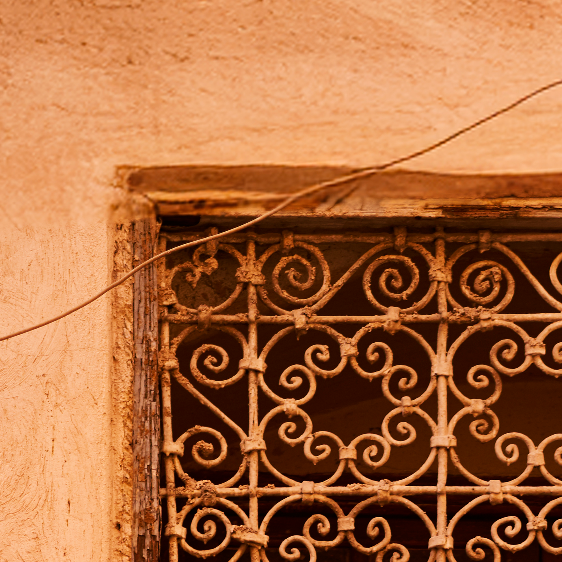 Decorative metal grille on a textured wall