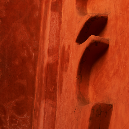 Close-up of a textured red surface with a circular cutout