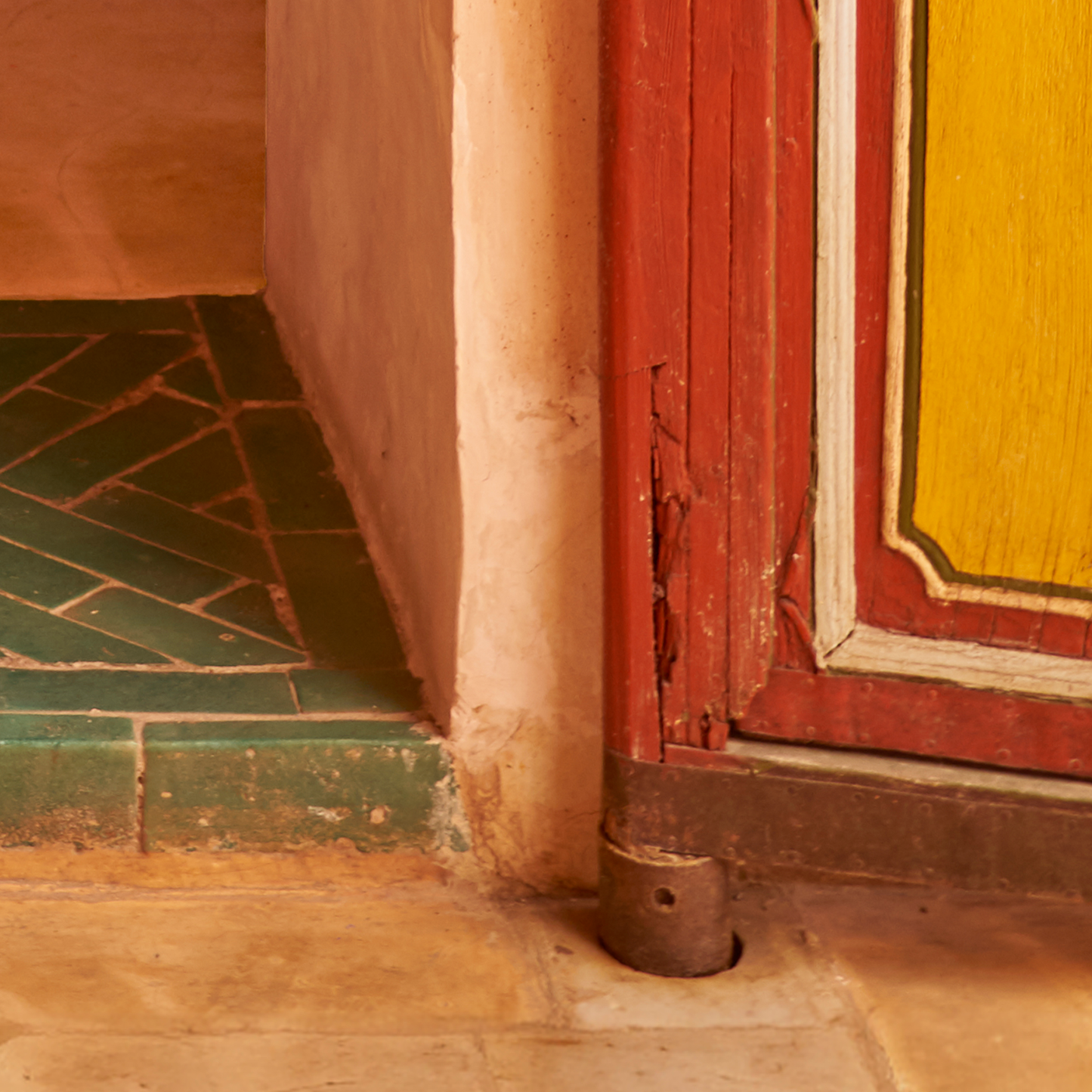 red and yellow doorway close up with green tiles