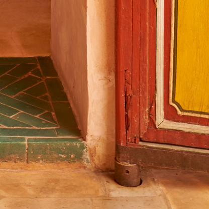 red and yellow doorway close up with green tiles