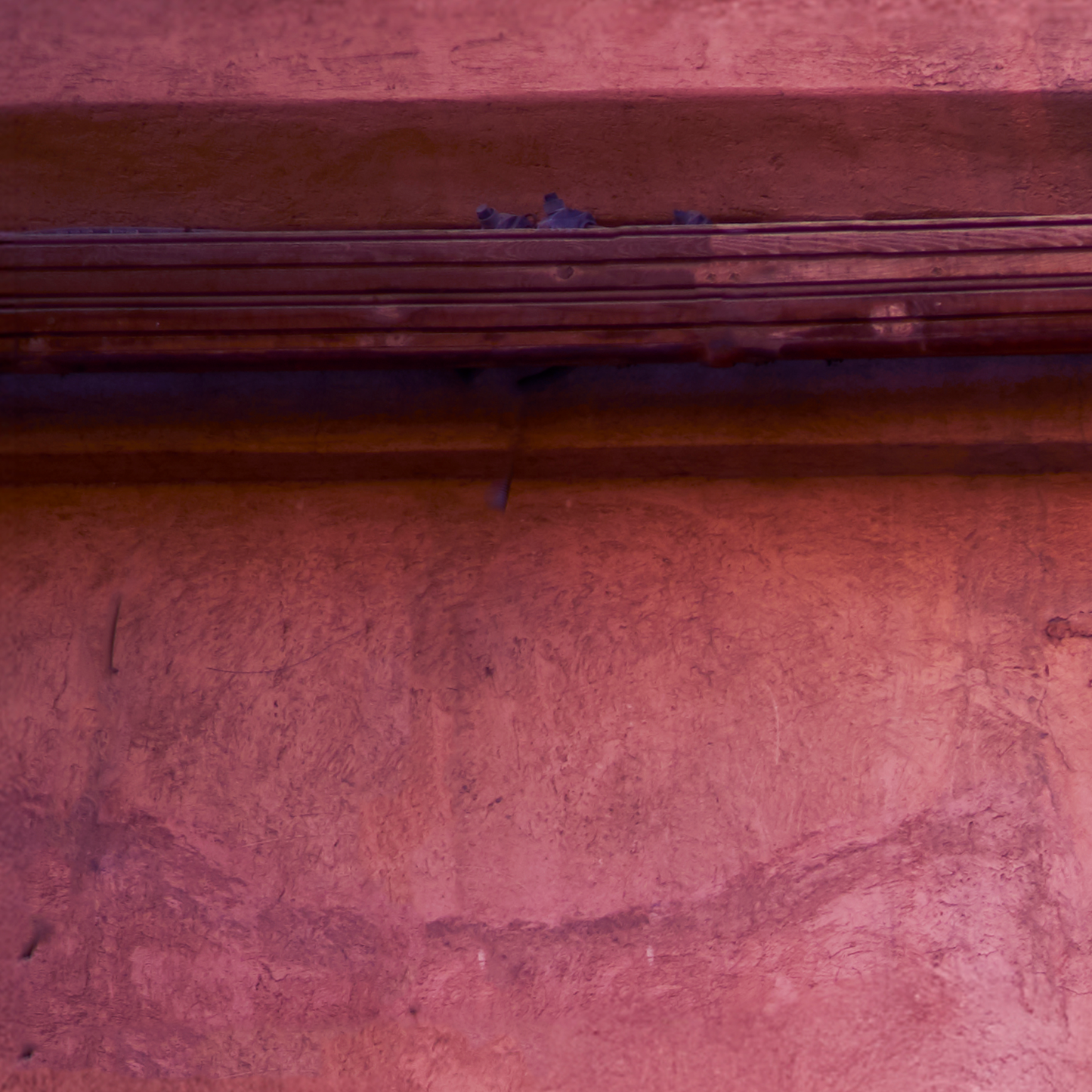 Close-up of a textured red-brown surface with horizontal lines
