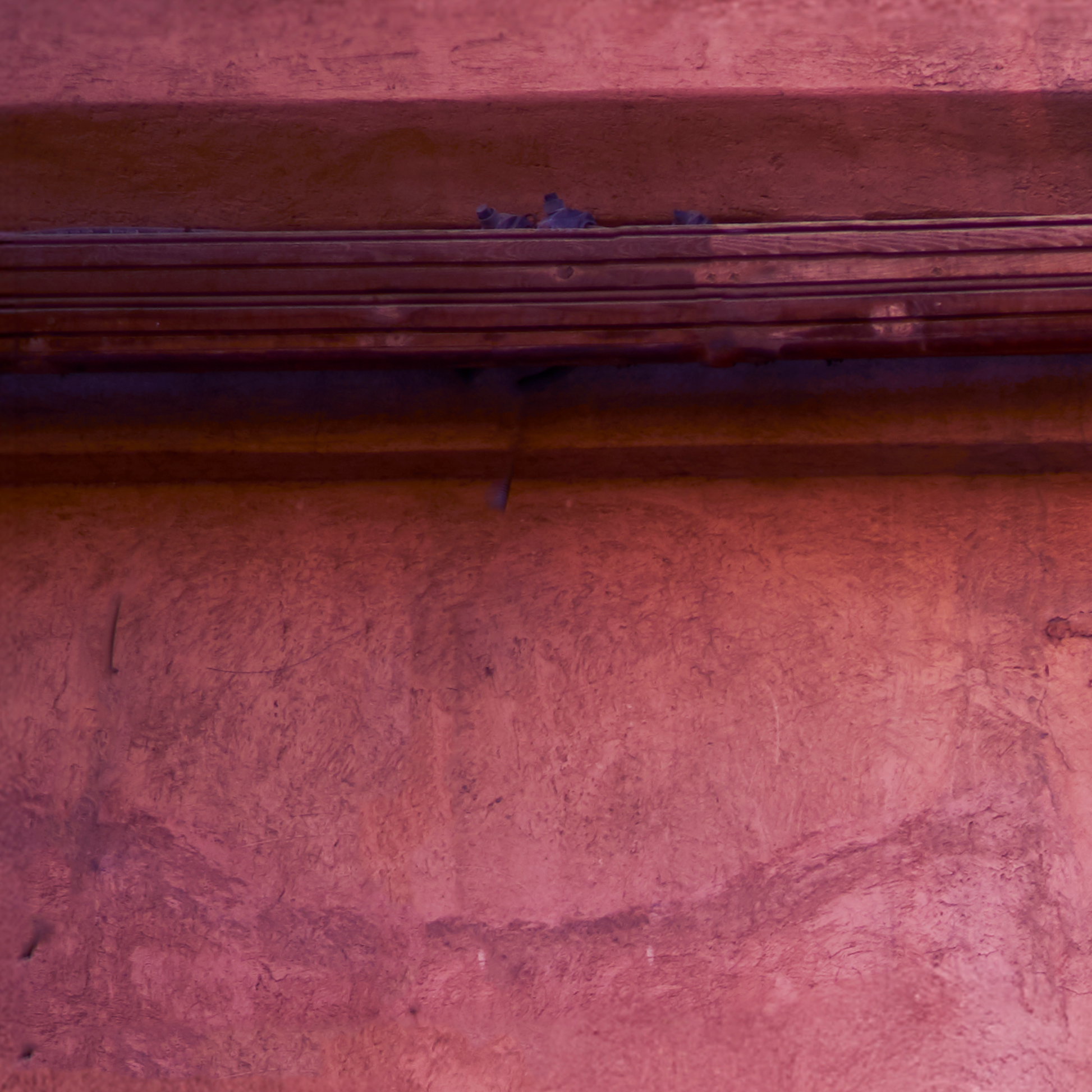 Close-up of a textured red-brown surface with horizontal lines