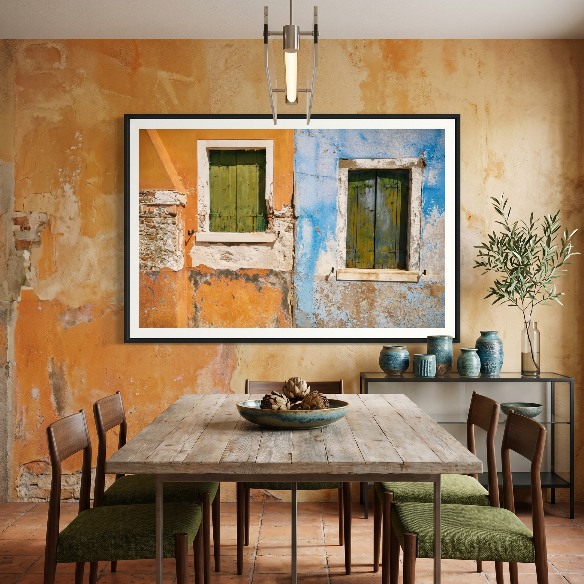 Dining room with a rustic table and chairs, framed artwork on the wall, and decorative items.