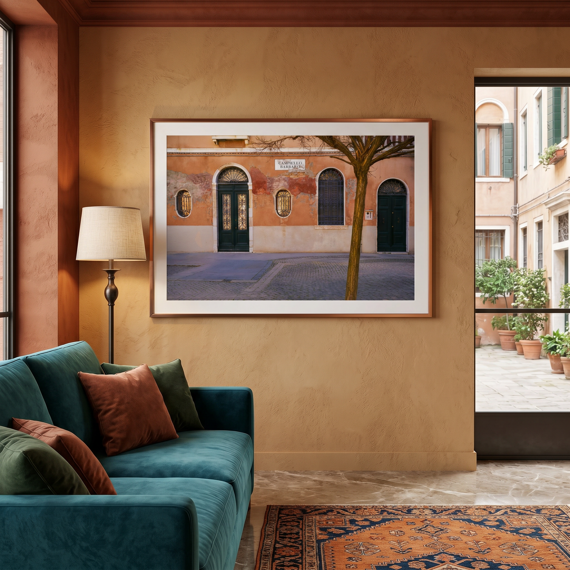 Living room with teal sofa, colorful rug, and framed artwork of a street scene.