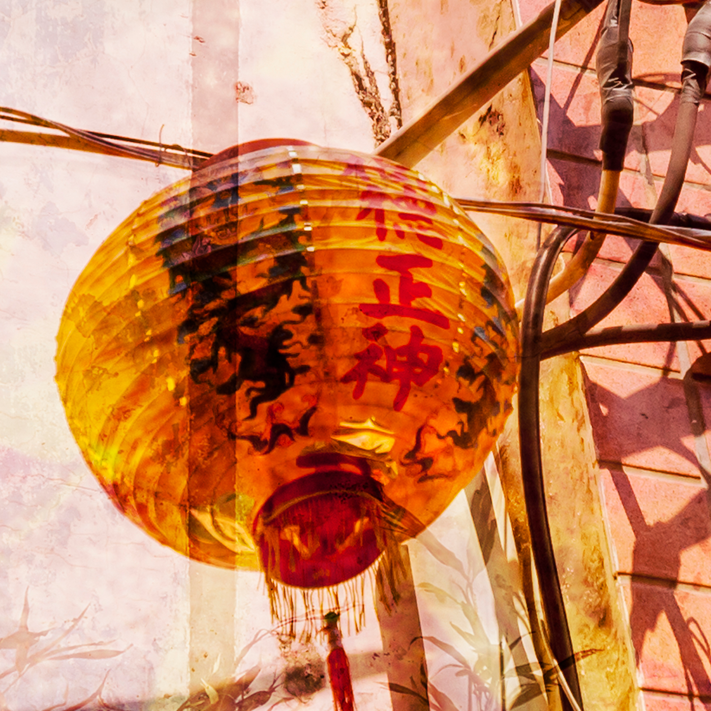 Traditional Chinese lantern with red text against a textured wall.