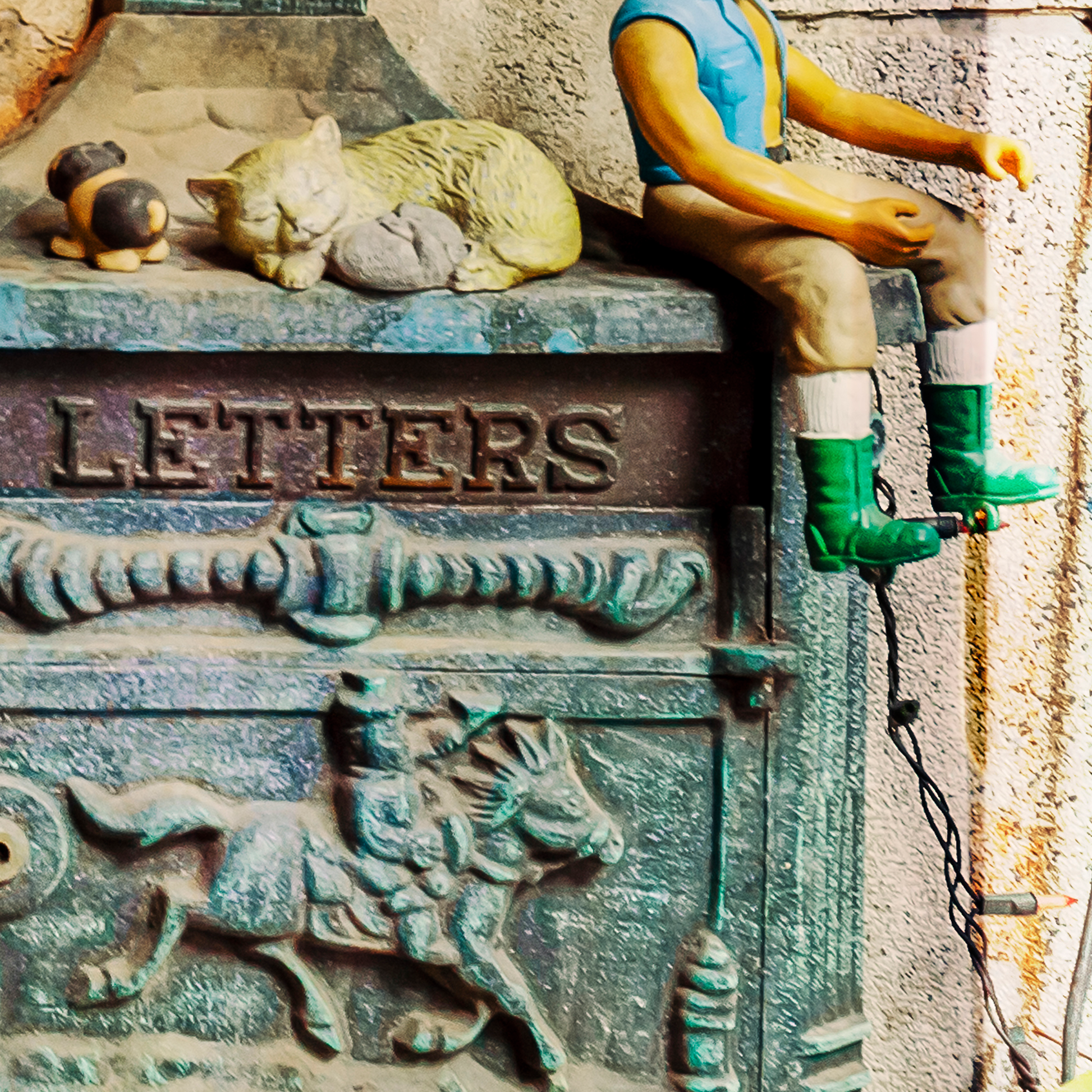 Toy figure of Mr T sitting on a post box with animals and 'LETTERS' text.