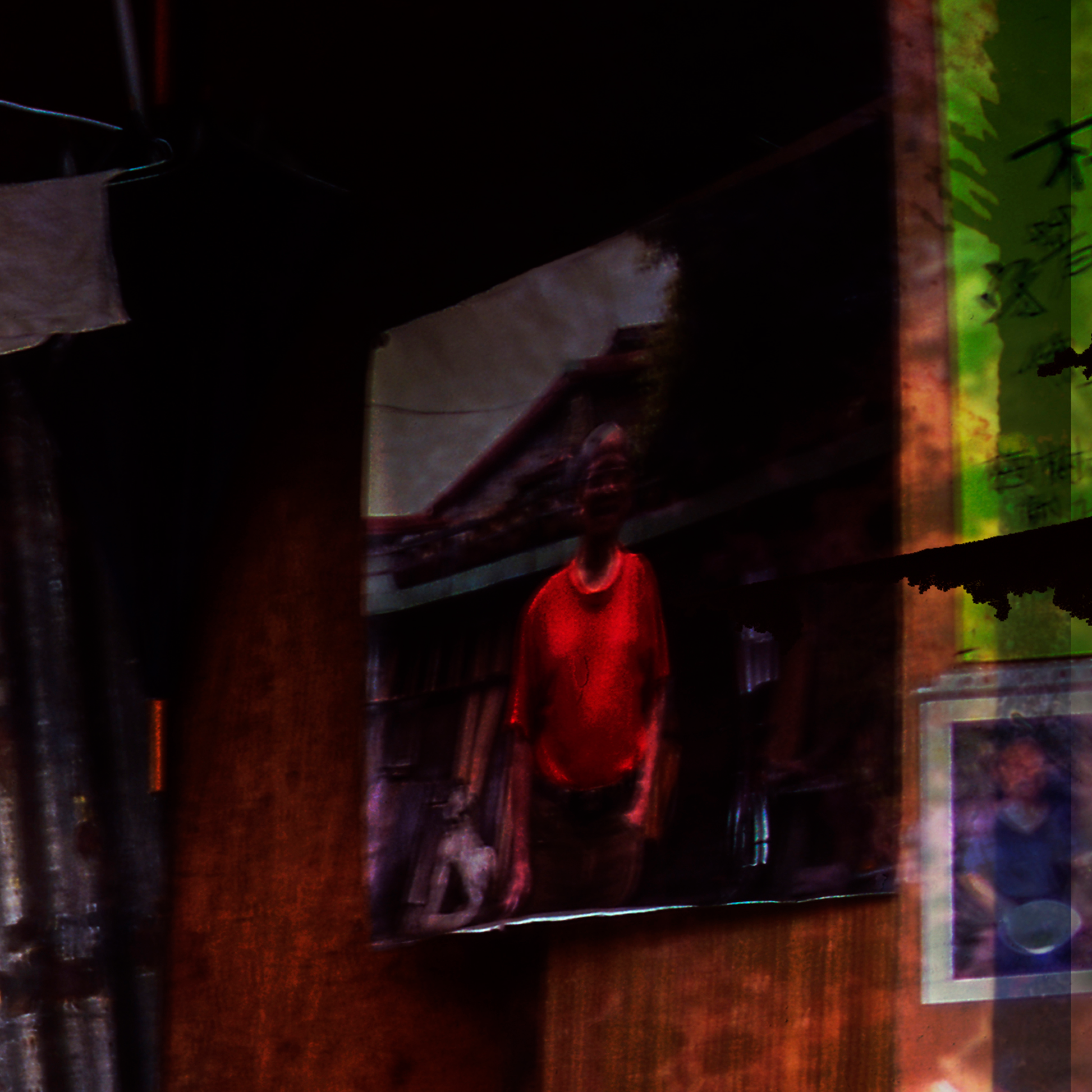Detail of photograph showing  a Person wearing a red shirt on  a dark  background