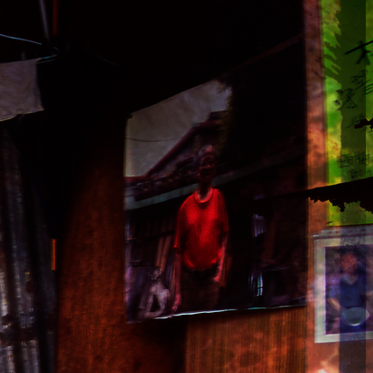 Detail of photograph showing  a Person wearing a red shirt on  a dark  background