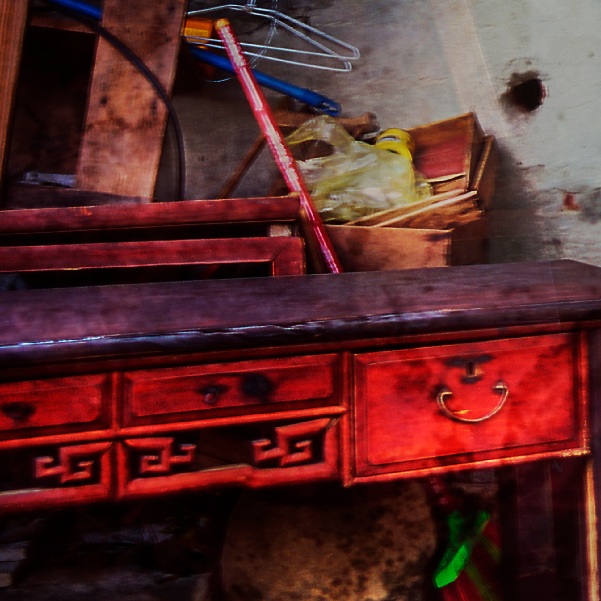 Close up of detail of photograph -Vintage wooden desk with drawers in a cluttered room